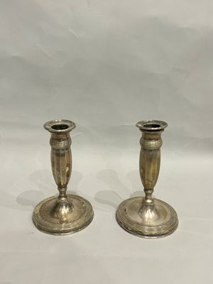 pair of antique brass candlesticks on a white background