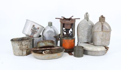 a lot of old metal pots and pans on the table