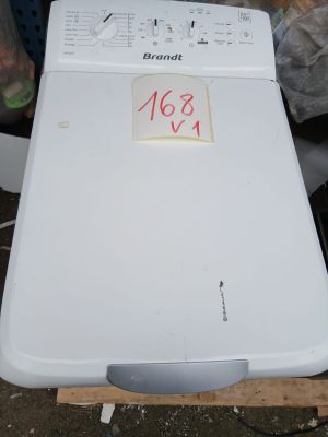 a white dishwasher sitting on top of a wooden pallet