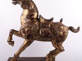 bronze statue of a horse with a rider on it ' s back