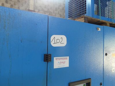 a blue machine that is sitting in a warehouse