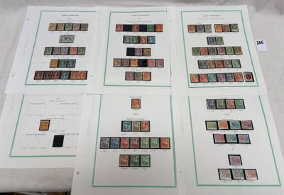 four sheets of stamps are on a table with a sheet of paper