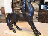 a statue of a horse that is standing on a table