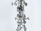 a metal sculpture of a man playing a trumpet