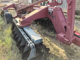 a red machine that is sitting in the grass