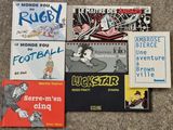 several children ' s books sitting on a carpet next to each other
