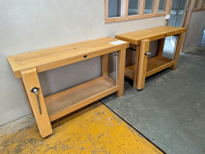 two wooden benches sitting next to each other in a room