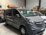 the grey van is parked in the garage of a warehouse