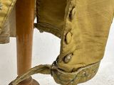 a close up of a coat on a wooden stand