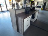 a desk with drawers and a cabinet in the middle of the room