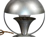 a silver lamp that is on top of a table