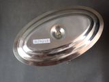an image of a silver plate with a metal lid on a table