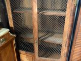 a cabinet that has a glass door on top of it