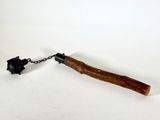 a wooden stick with a chain attached to it