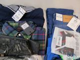 a lot of clothes and a wallet on the table