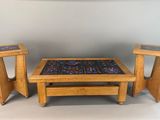 three tables and two stools that are made out of wood