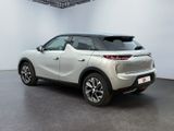 the rear end of a white suv parked in a room
