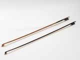 a pair of two wooden and metal poles on a white surface