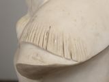 a white statue of a man with a mustache on it ' s head