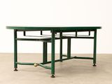 a green table with two chairs sitting on top of it