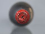 a close up of a bottle of wine with a star on it