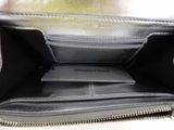 the inside of a black purse with a silver zipper