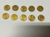 a bunch of gold coins sitting on top of a white table