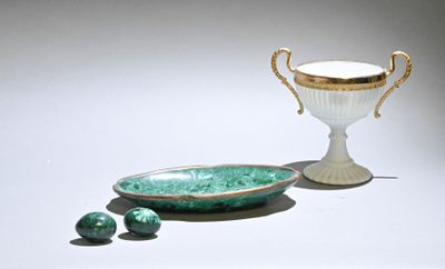 a green bowl and a white cup on a table