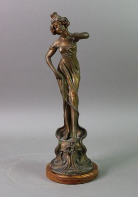 bronze statue of a woman holding a flower on a wooden base