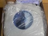a cardboard box with a toilet in it that is wrapped in plastic