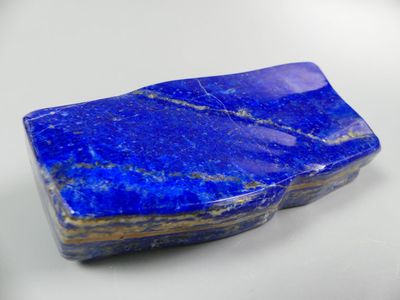 a close up of a blue stone on a white surface