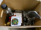 a cardboard box filled with assorted items on the floor