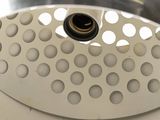 a metal strainer with holes on it on a white surface