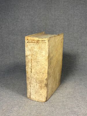 an old book sitting on top of a table next to a gray background