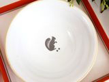 a white plate with a picture of a cat on it in a red box