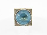 a close up of a ring with a blue stone in it