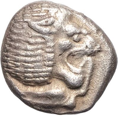 a silver coin with a face on it on a white background
