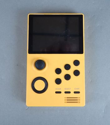 a close up of a yellow gameboy sitting on top of a table