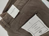the back pocket of a pair of brown pants with a tag on it