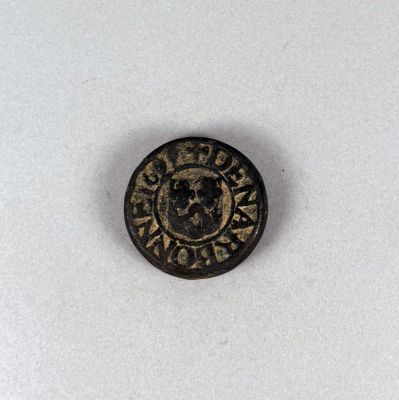 un gros plan d'une pièce de monnaie sur laquelle figurent un crâne et une croix