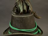 a brown hat with a feather on top of it