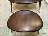 two tables that are sitting next to each other on the floor