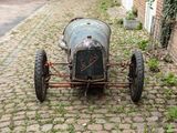 an old car that is sitting on the side of the road