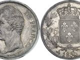 a close up of a coin with a crown on top of it