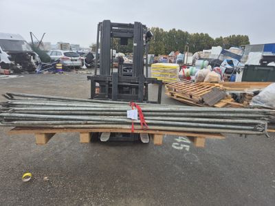 a forklift with a bunch of steel rods on the back of it