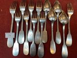 a lot of forks and spoons that are on a table