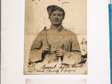 an old photo of a woman holding a tennis racquet on top of a table