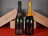 two bottles of champagne sitting next to each other on a table