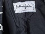 a close up of a black and white jacket with a label on it