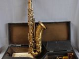 a saxophone sitting in a case on a table